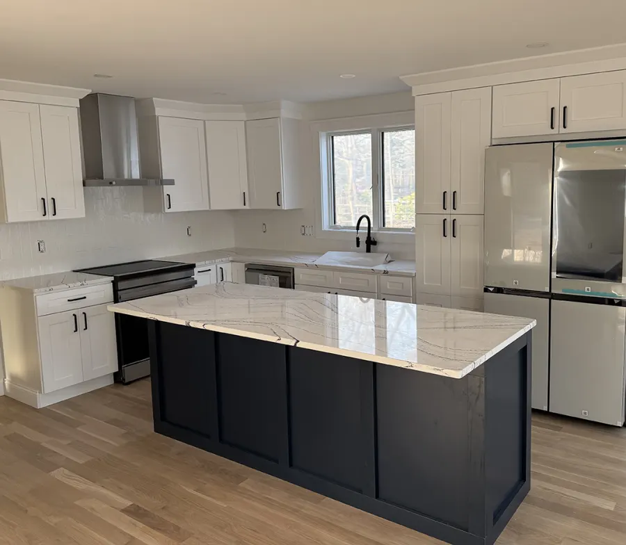 New kitchen with white cabinets and a dark island