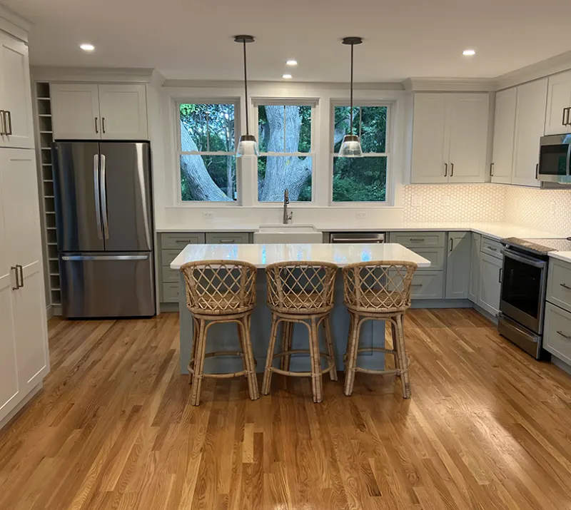 Kitchen with oak floors and a three-stool island